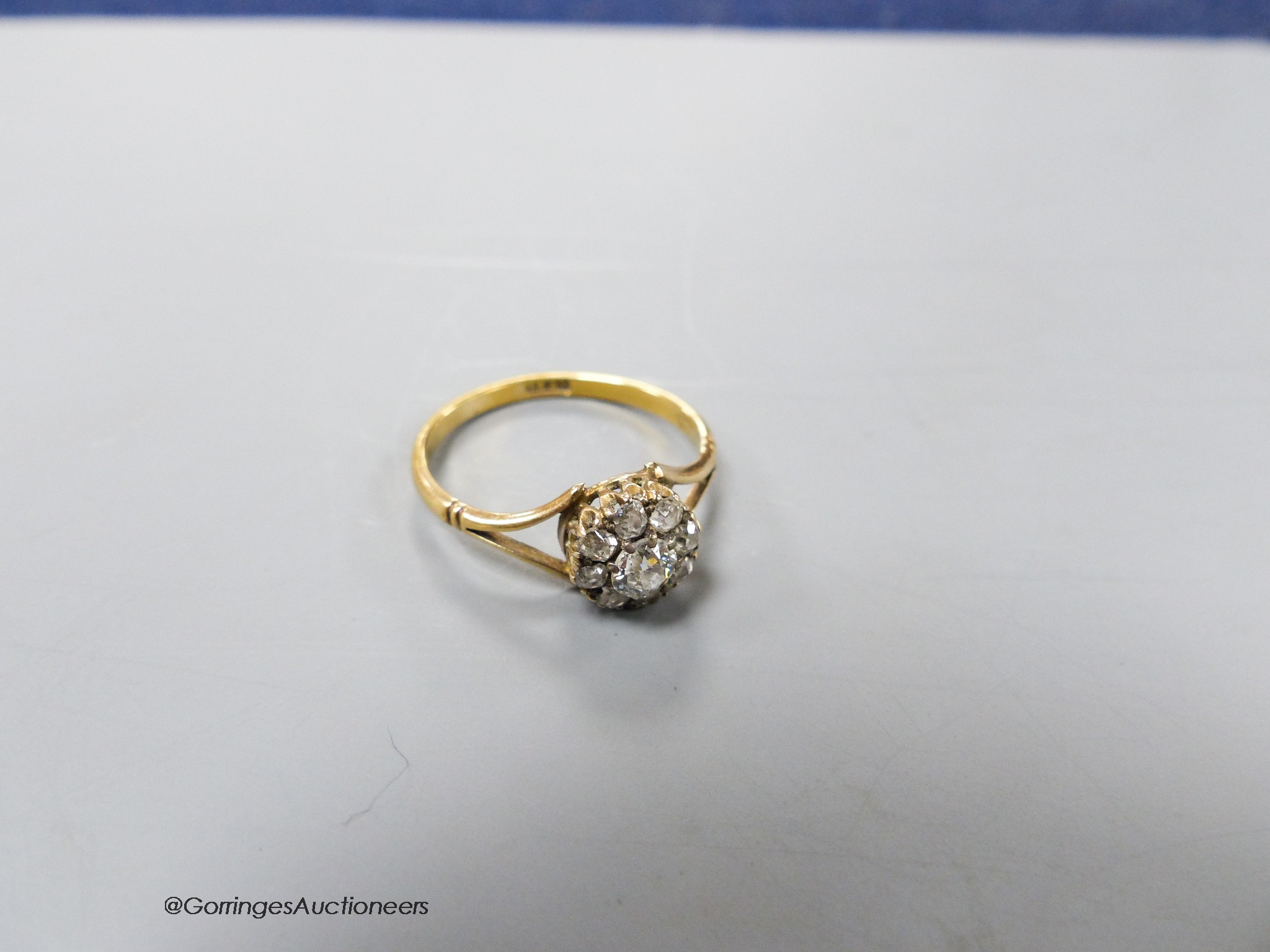 An 18ct and old round cut diamond set cluster ring, size Q, gross weight 2.5 grams.